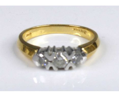 A modern 18ct gold diamond three-stone ring, the centre stone weighing approx 0.16 carats, the outer stones each weighing app