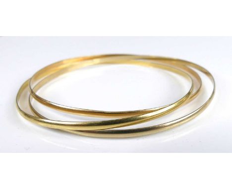 A three-colour yellow metal bangle triptych, unmarked but tests as approx 18ct gold, 15.2g, dia.7cm 