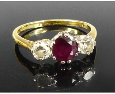 An 18ct yellow and white gold, ruby and diamond three-stone ring, the centre ruby measuring approx 5.75 x 2.95mm, weight esti