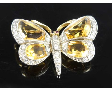 A yellow and white metal, citrine and diamond butterfly brooch, the wings each set with a trapezoid cut and a truncated oval 