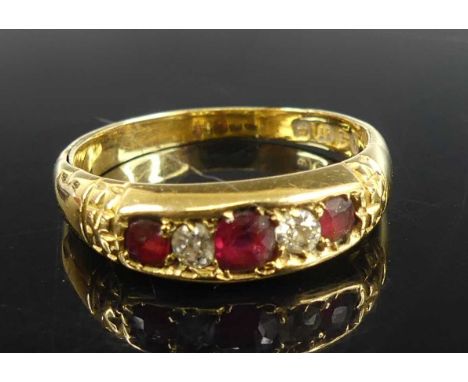 A Victorian 18ct yellow gold, ruby and diamond half-hoop ring, comprising three graduated Old European cut diamonds alternati