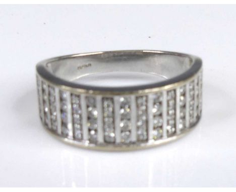 A contemporary 18ct white gold and diamond half-hoop ring, arranged as fifteen bands of four channel set round brilliant cut 