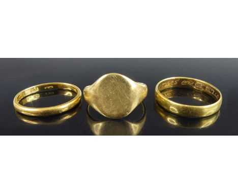 An 18ct gold plain signet ring, London 1921, size L; together with an 18ct gold wedding band (worn and slightly twisted), siz