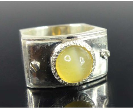 A contemporary silver chrysoberyl cats eye ring, the cabochon stone measuring approx 8.2 x 6.9mm, sponsor YC, size O, 12.3g