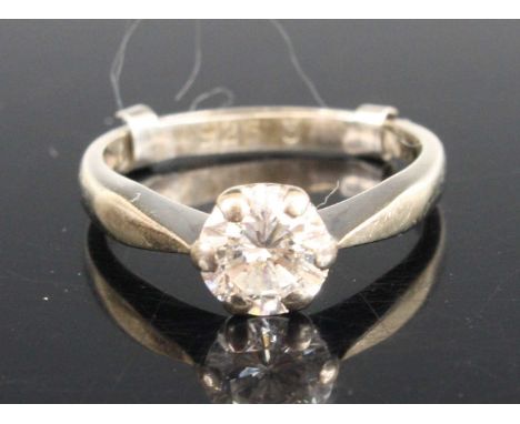 A white metal diamond solitaire ring, featuring a round brilliant cut diamond in a six-claw setting, diamond dimensions appro