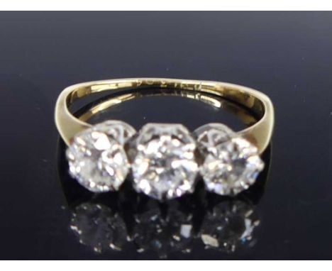 An 18ct gold diamond trilogy ring, arranged as three claw set round cuts, each weighing approx 0.29 carats (centre stone and 