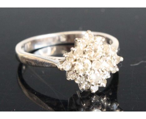An 18ct white gold diamond navette style cluster ring comprising 4 round brilliant and 16 single cut diamonds in claw setting