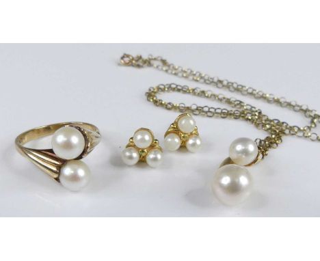 A modern 18ct gold and cultured pearl set pendant, height 2.5cm larger pearl dia. 8.1mm, having diamond point set bale, and o