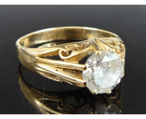 A 9ct yellow gold gent's diamond solitaire ring, featuring a round brilliant cut diamond claw set within an open scrollwork m