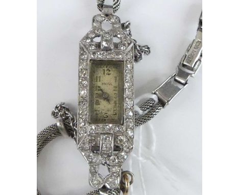 Am Art Deco platinum and diamond set cocktail watch, having an Arabic tank dial within a surround of small round cut diamonds