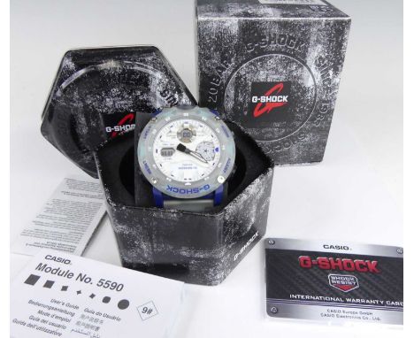 A gent's Casio G-Shock quartz wristwatch, model No.5590, with opaque and blue plastic case, opaque plastic bracelet, with pap