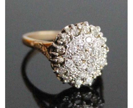 A yellow and white metal diamond oval cluster ring, featuring 29 round brilliant cut diamonds in claw settings, with engraved