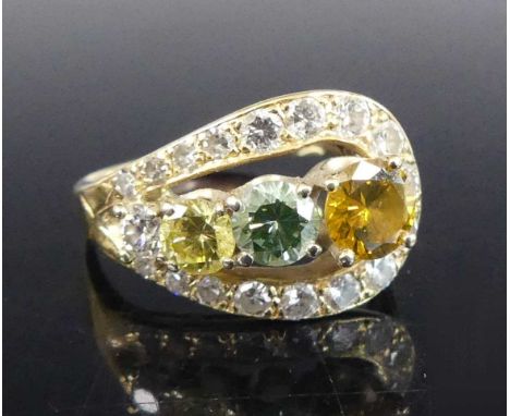 A yellow metal stirrup shaped diamond dress ring, featuring four treated coloured diamonds within a border of 17 graduated ro