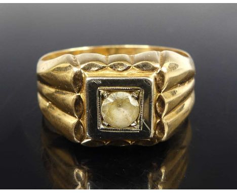 A continental gent's yellow metal and white sapphire set signet ring, the round cut sapphire in a raised white metal flanked 