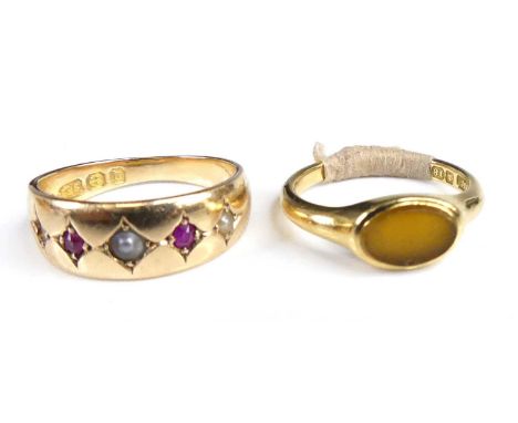 A late Victorian 15ct gold, ruby and seed pearl set half-hoop ring, the five alternating stones being gypsy set (one pearl mi
