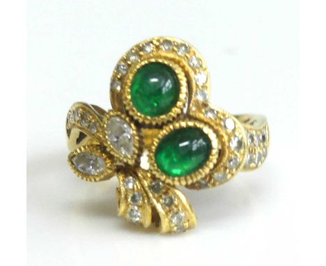 A yellow metal, emerald and diamond floral cluster ring, designed as a posy with two oval cabochon emeralds, two marquise and