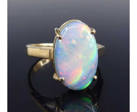 A 9ct gold opal dress ring, the four-claw set opal cabochon measuring approx 14.5 x 9 x 4mm, size L, 2.9g