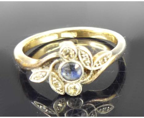 An Edwardian 18ct gold sapphire and diamond flower head dress ring, the bezel set round cut sapphire weighing approx 0.13 car