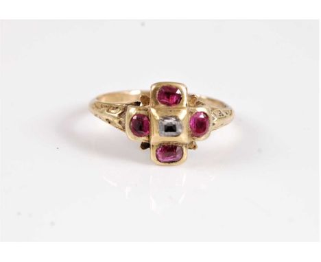 An 18th century ruby and diamond ring, the central table cut diamond set to each side with an oval ruby, all in rubover mount
