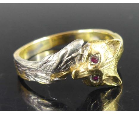 A modern 18ct yellow and white gold band ring, fashioned as a fox's head meeting its tail, the eyes as small round cut rubies