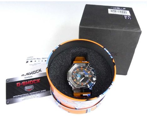 A Casio G-Shock men's stainless steel quartz wristwatch, model No. 5611, having orange plastic bracelet, with papers, printed