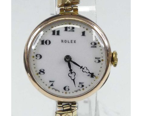 A vintage lady's Rolex 9ct gold manual wind wristwatch, having a signed white enamel Roman dial, plain back cover, case by Ro