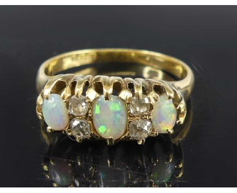 A Victorian 18ct yellow gold, opal and diamond half-hoop ring, featuring three graduated opal cabochons alternating with four