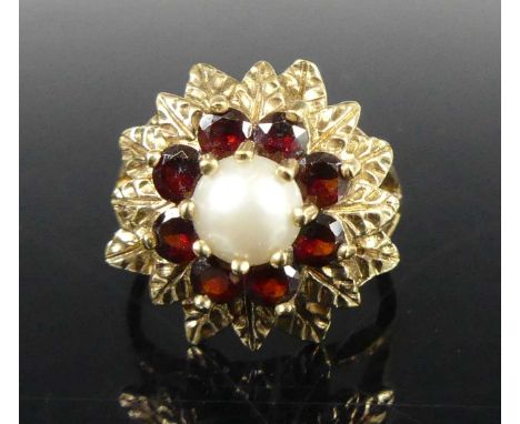 A modern 9ct gold, cultured pearl and garnet flower head cluster ring, pearl dia.5.8mm, the stones in a tiered setting, setti