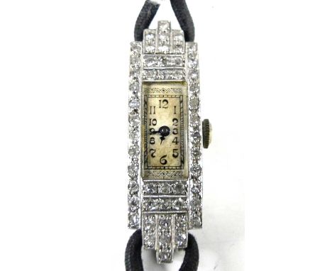 An Art Deco platinum and diamond set lady's cocktail watch, having a silvered Arabic tank dial within a surround of 50 pavé s
