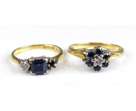 Two 18ct yellow and white gold, sapphire and diamond rings, being a three-stone with centre emerald cut Sapphire and one roun