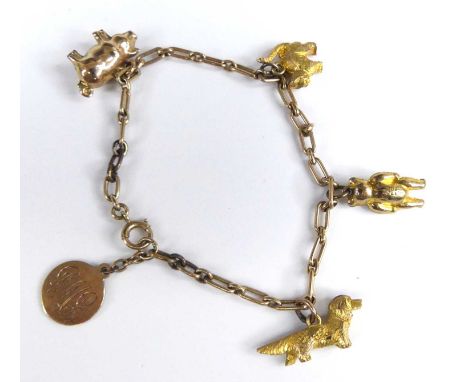 A child's 9ct gold bracelet, containing assorted 9ct gold charms to include a dog, teddy-bear, cat and pig, 7.9g