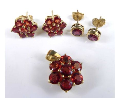 A pair of modern 9ct gold and Malawi ruby set ear studs, the bezel set round cuts total weight approx 0.81 carats; together w
