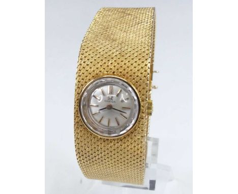 An Omega lady's 18ct gold cased bracelet watch, having a signed silvered dial with baton markers, manual wind movement, dial 