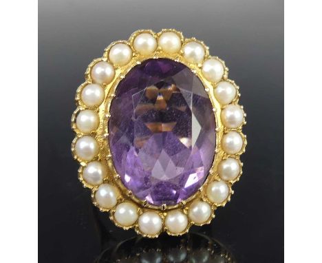 A 9ct yellow gold, amethyst and pearl oval cluster ring, the centre amethyst in a claw setting, within a border of twenty 3.1
