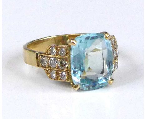 An 18ct gold, aquamarine and diamond dress ring, arranged as a four-claw set oval cut aquamarine measuring approx 11.2 x 8.5 