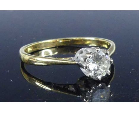 A yellow and white metal diamond solitaire ring, featuring a round brilliant cut diamond in an eight-claw setting, diamond di