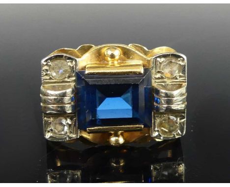 An 18ct gold heavy set dress ring, having a centre rectangular blue paste stone and four rose cut diamonds, paste stone dimen