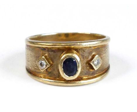 A contemporary 18ct gold, sapphire and diamond set tapering band ring, the bezel set oval cut sapphire measuring approx 4.2 x