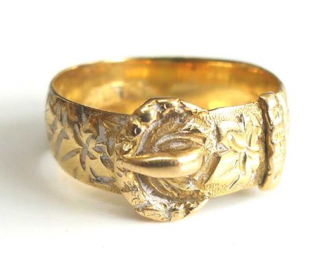 An 18ct yellow gold buckle ring engraved with foliate detail, ring w.6.45mm, size P½, gross weight 5.2g, partial hallmark for