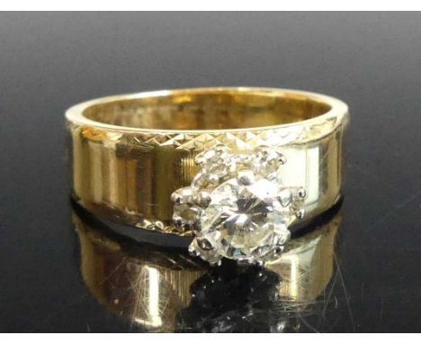 A yellow and white metal diamond circular cluster ring, comprising a round brilliant cut diamond surrounded by six single cut