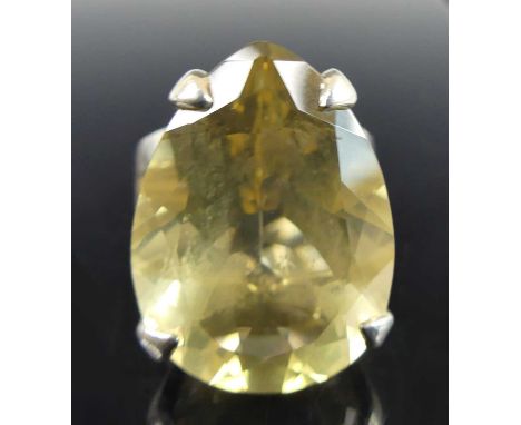 A silver citrine dress ring, the pear cut citrine measuring approx 24.1 x 17.7 x 11.35mm and estimated as weighing 28.14 cara