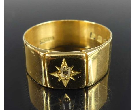 An 18ct yellow gold diamond set signet ring, comprising an old rectangular cut diamond in a star setting within a rectangular