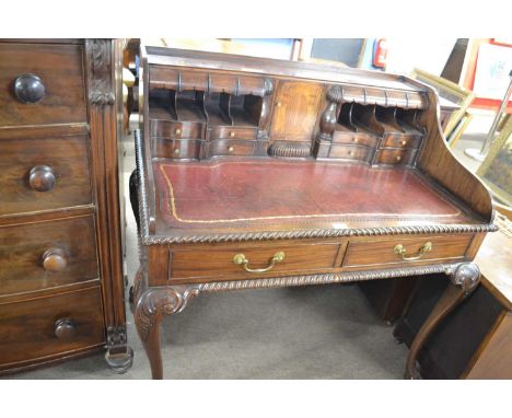 A 20th Century reproduction mahogany Carlton House type writing desk with red leather inset, small drawers, pigeon holes and 