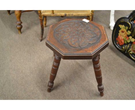 A small Arts &amp; Crafts type low table with octagonal oak top with Celtic knot type detail, raised on four turned legs