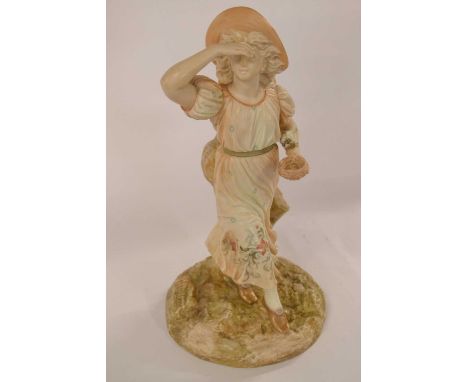 Royal Worcester Hadley Figure of a Young Girl holding a birds nest, late 19th century, modelled in blush ivory with painted f