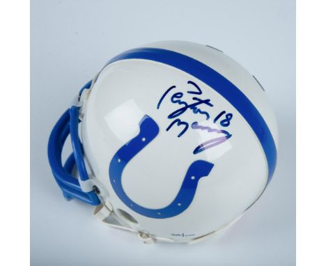 A white and blue Indianapolis Colts mini helmet, personally autographed by Peyton Manning. Riddell backstamp. Marked 306/500.