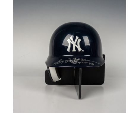 A New York Yankees collector's mini baseball batting helmet from Riddell. This item has a plexiglass display case which measu