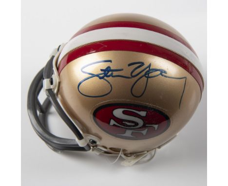 A mini replica of the San Francisco 49ers helmet, signed by Steve Young. This item comes in a protective case that measures: 