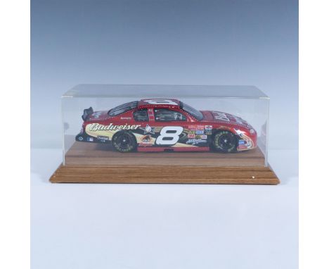 Die-cast metal with plastic parts, 1:24 scale replica of the NASCAR racer. This item has a wooden base with removable plastic