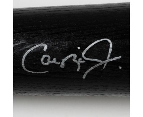 A black Louisville Slugger bat autographed by Baltimore Oriole, Cal Ripken Jr. Certificate of authenticity from Goldin Sports